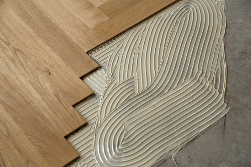 Unfinished parquet installation in a renovated room.
